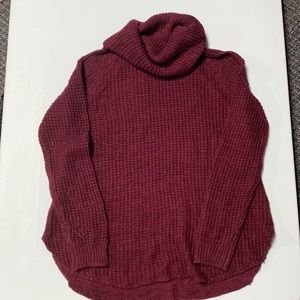 Maroon turtle neck sweater.